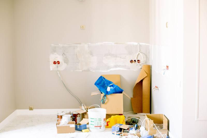 Room mid-refurbishment with new wiring, tools and paint tins